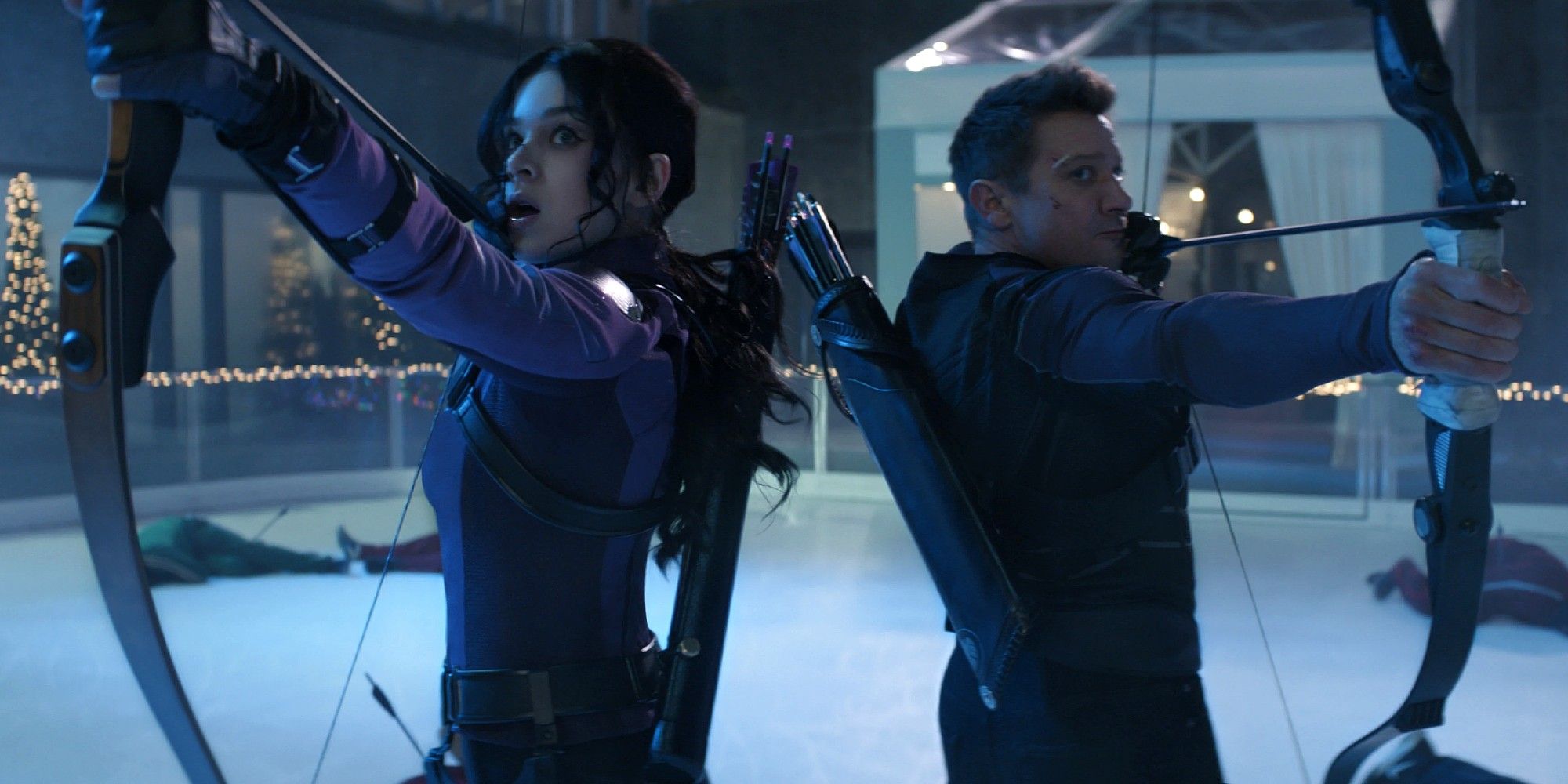 Hailee Steinfield and Jeremy Renner as Kate and Clint back to back with bow and arrows drawn in Hawkeye.