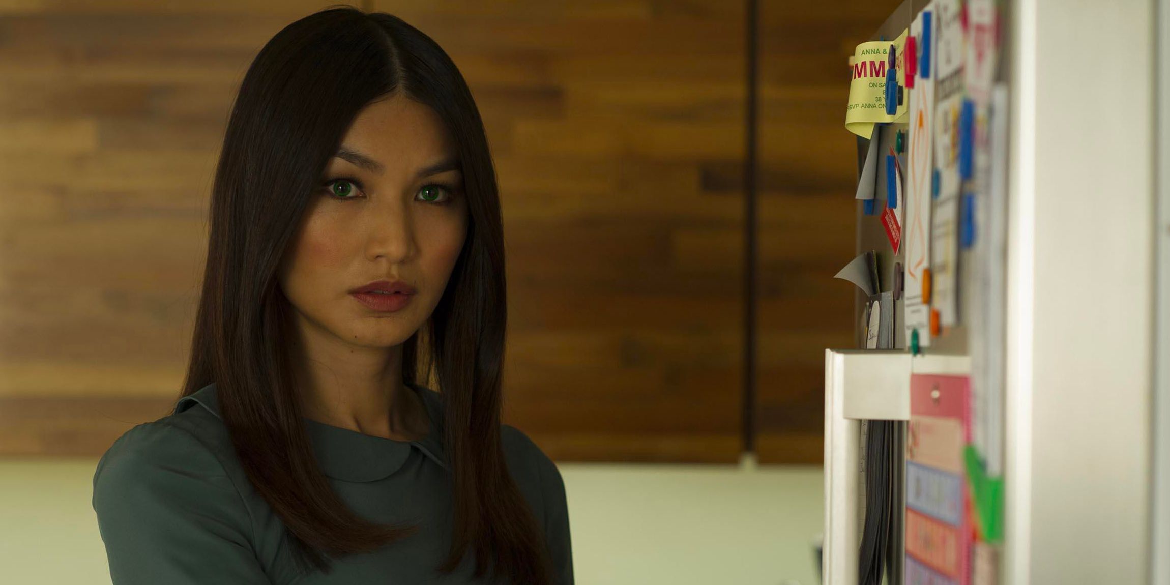 A woman smiling, standing by a fridge in a scene from Humans.