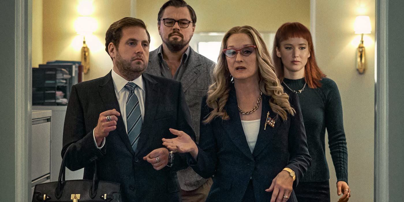 Doctor Randall (Leondardo DiCaprio) and his assistant Kate (Jennifer Lawrence) walking behind the President (Meryl Streep) and her aide Jason (Jonah Hill) in Don't Look Up 