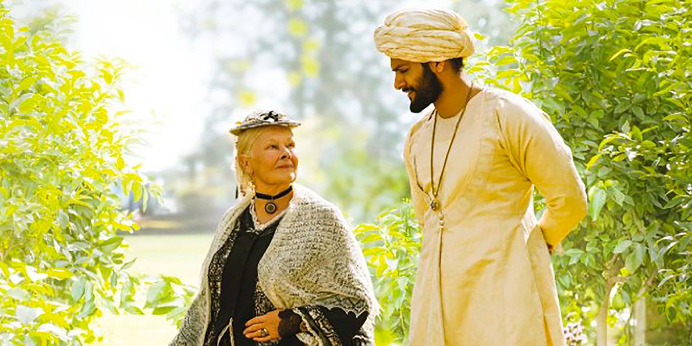 Victoria and Abdul walking on the garden in Victoria & Abdul.