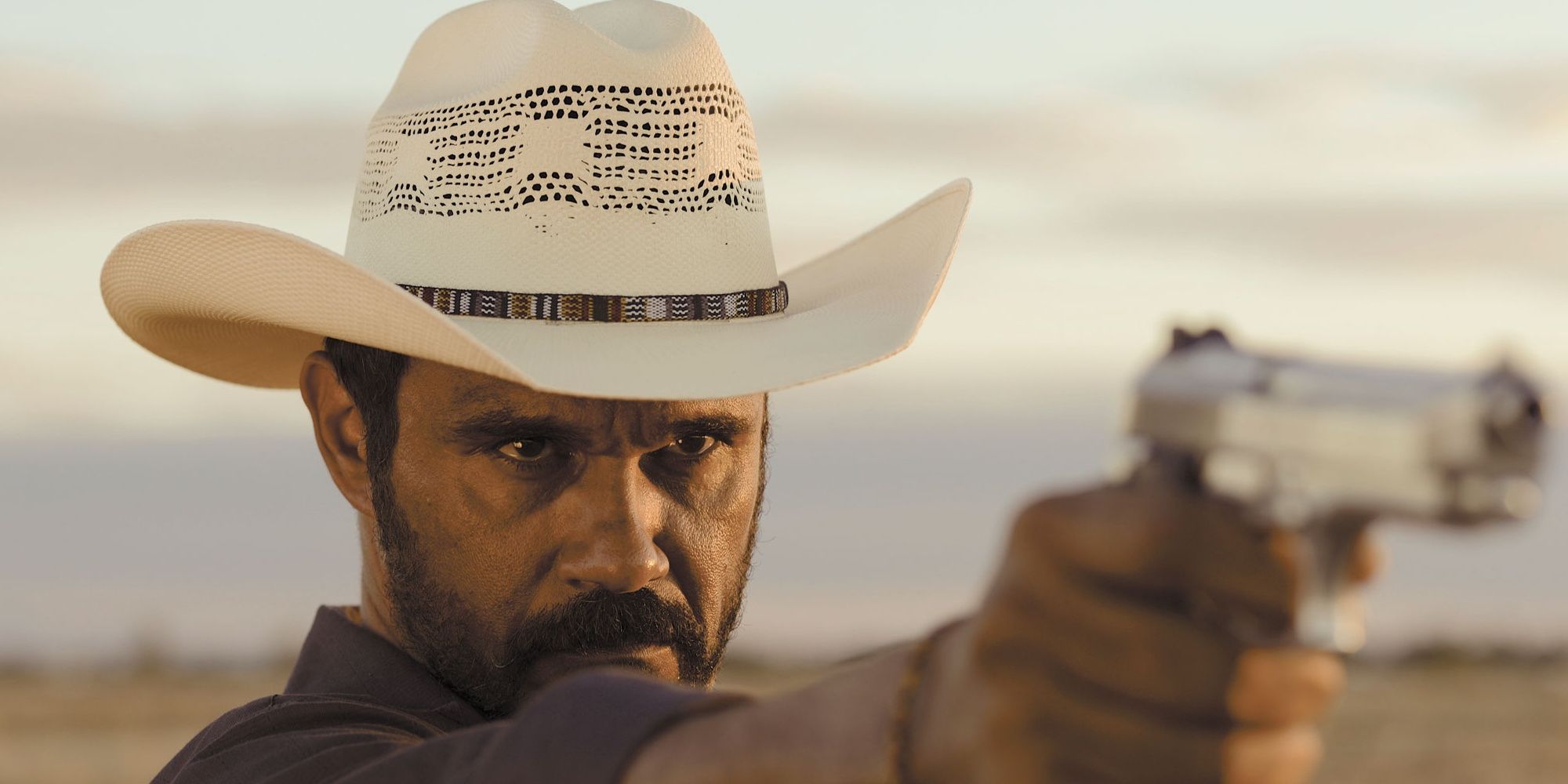 A man aiming a handgun