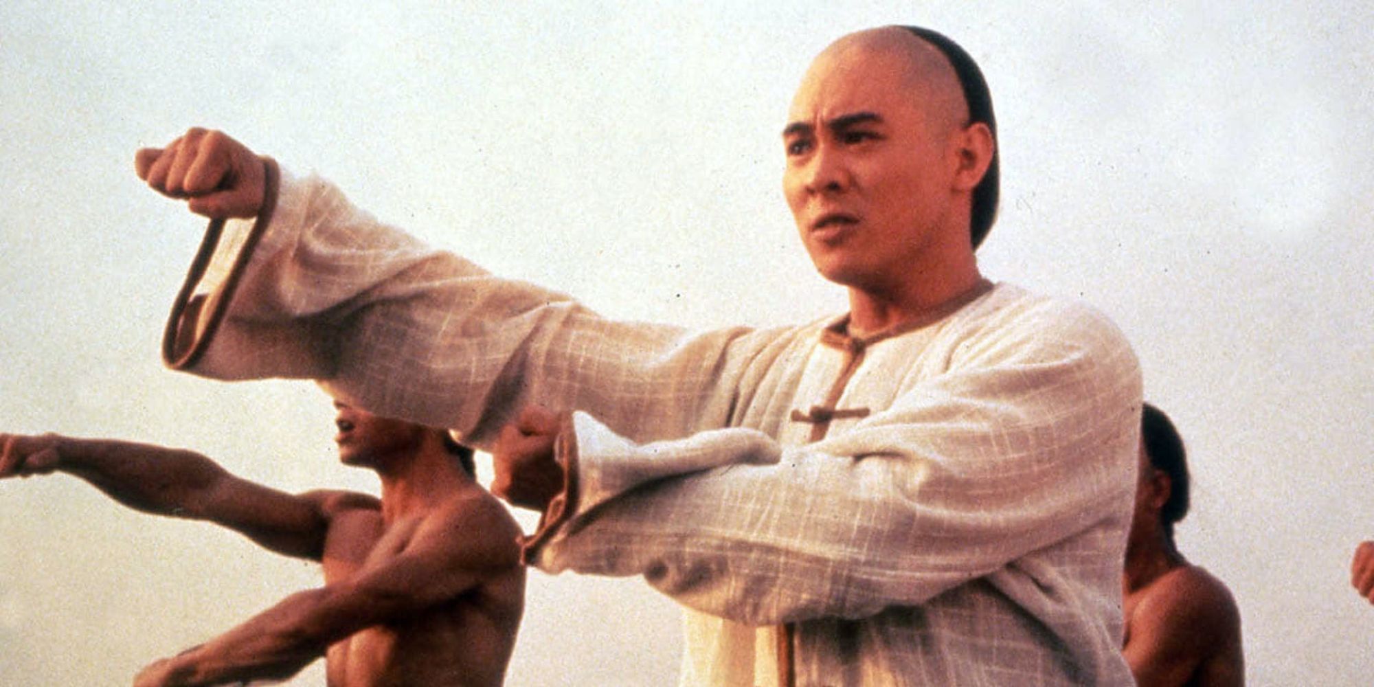 Jet Li in a martial arts stance with others in Once Upon A Time In China.
