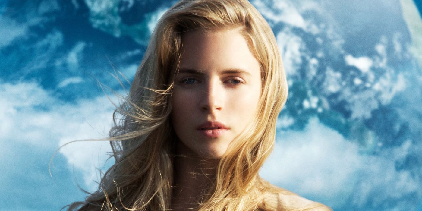 Rhoda in Another Earth, looking pensively into the camera while the Earth is hovering behind her