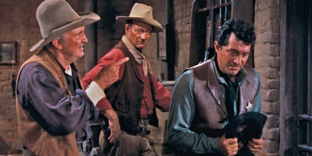 John Wayne and Dean Martin listening to Walter Brennan in Rio Bravo