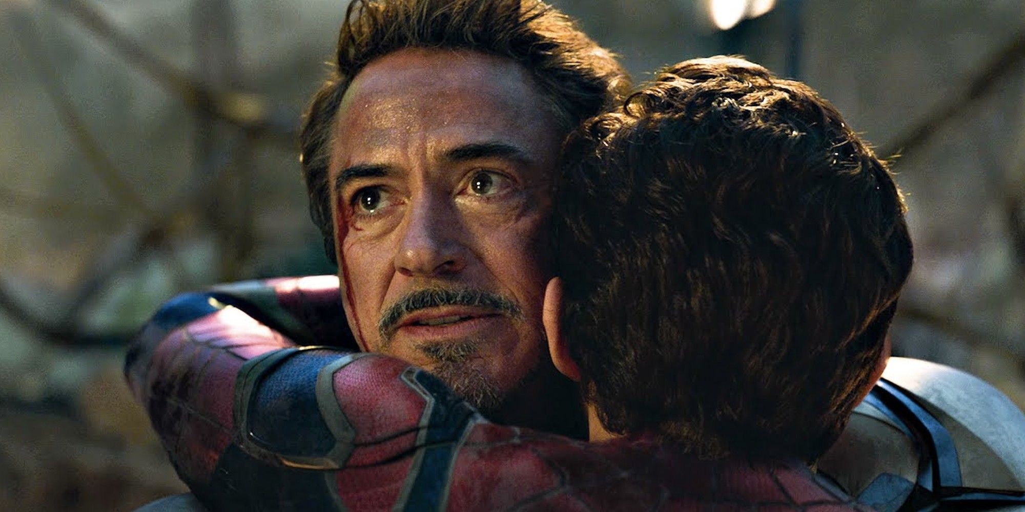 Robert Downey Jr as Tony Stark hugging Tom Holland's Peter Parker in Infinity War