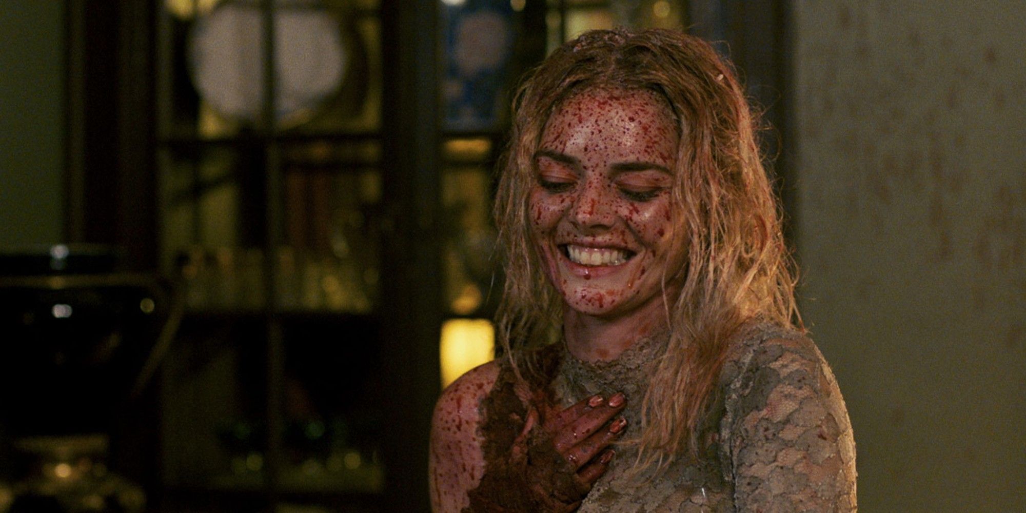 Samara Weavering's character smiling with blood all over her