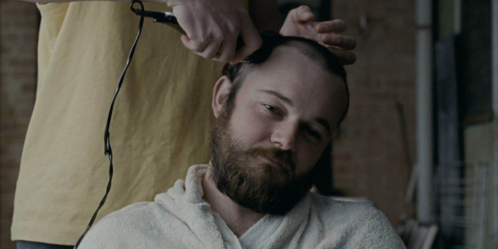 A man getting his head shaved