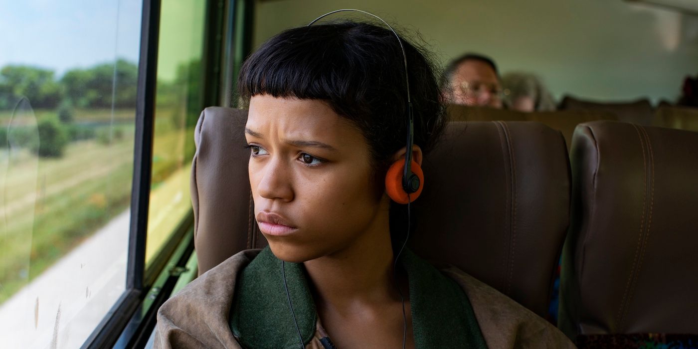 Taylor Russell as Maren in a bus looking out the window in Bones and All