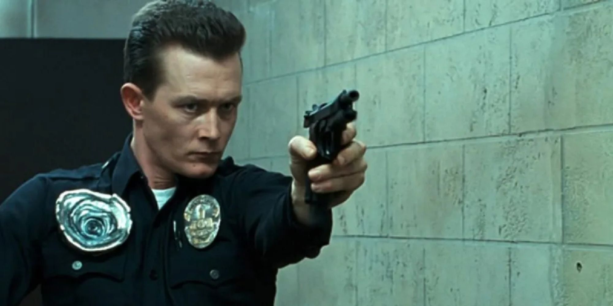 The T-1000 dressed as a cop aiming a gun at someone off-camera in Terminator 2 - 1991