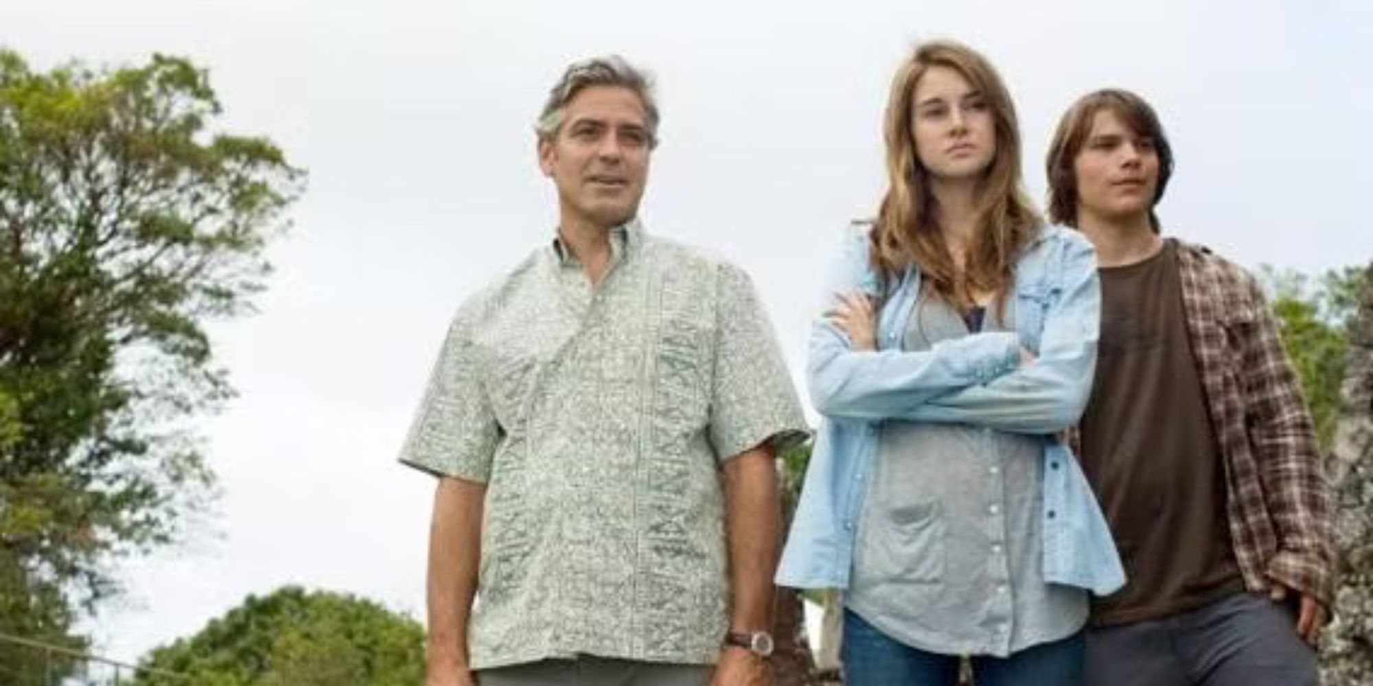 George Clooney, Shailene Woodley, and Nick Krause standing together in The Descendants (2011)