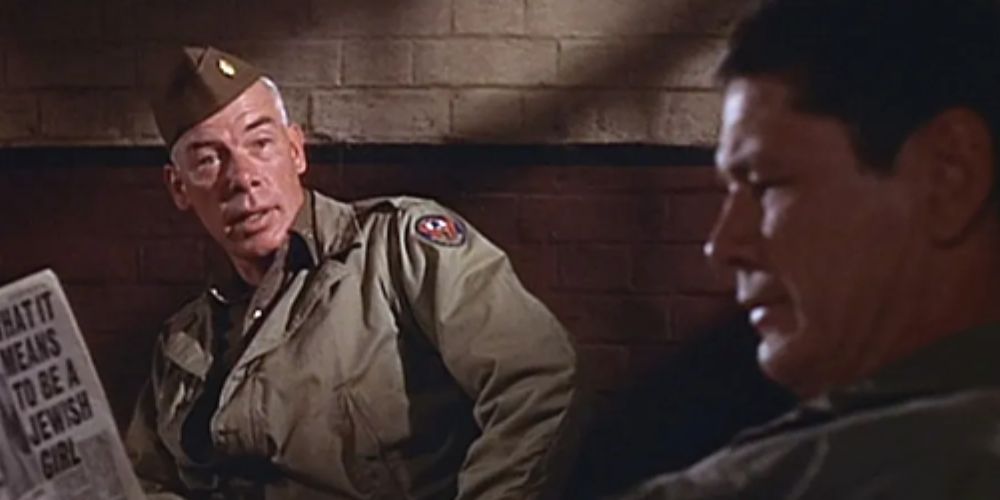 Lee Marvin in conversation with Charles Bronson in The Dirty Dozen.