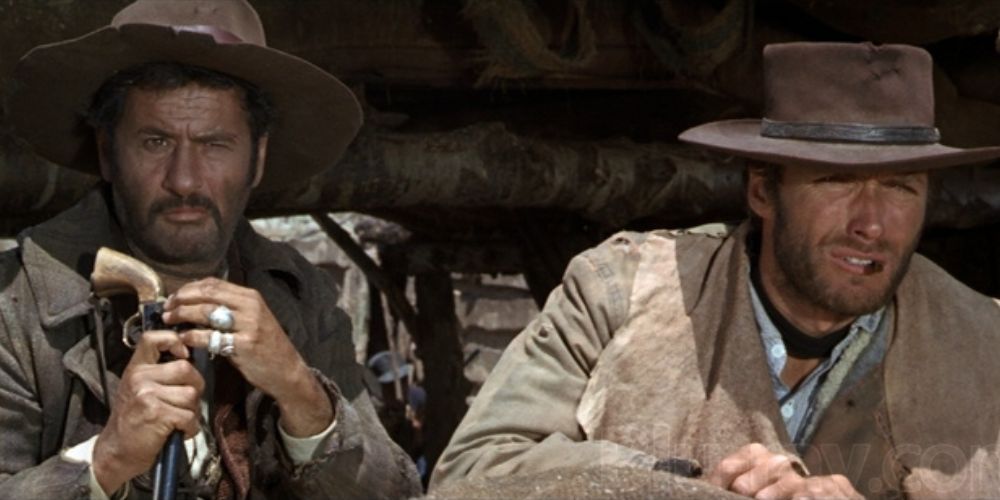 Eli Wallach sitting next to Clint Eastwood on a wagon in The Good, the Bad and the Ugly