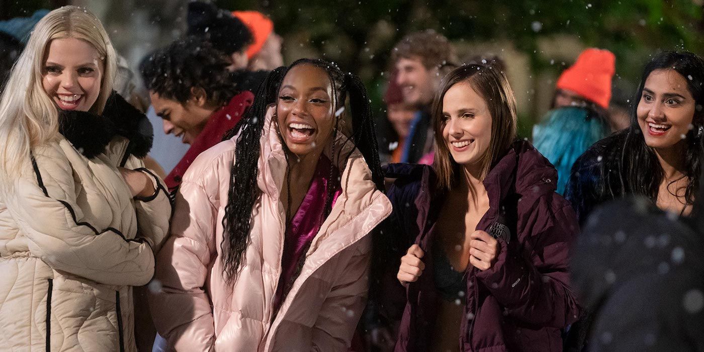 Leighton, Whitney, Kimberly, and Bella laughing under the snow in The Sex Lives of College Girls.