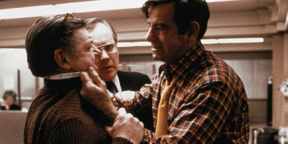 Walter Matthau grabbing a man by the collar of his shirt in The Taking of Pelham One Two Three (1974)
