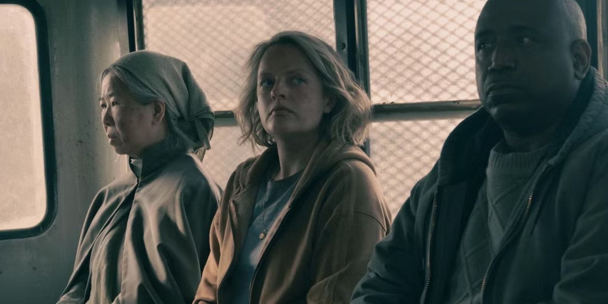 June sitting in the back of a Gilead car