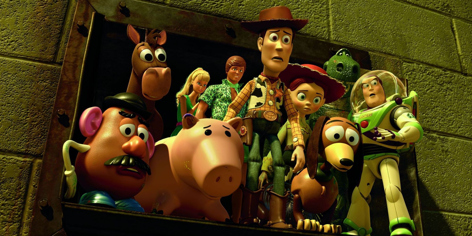 The toys in Toy Story 3 huddled together on a ledge looking worried.