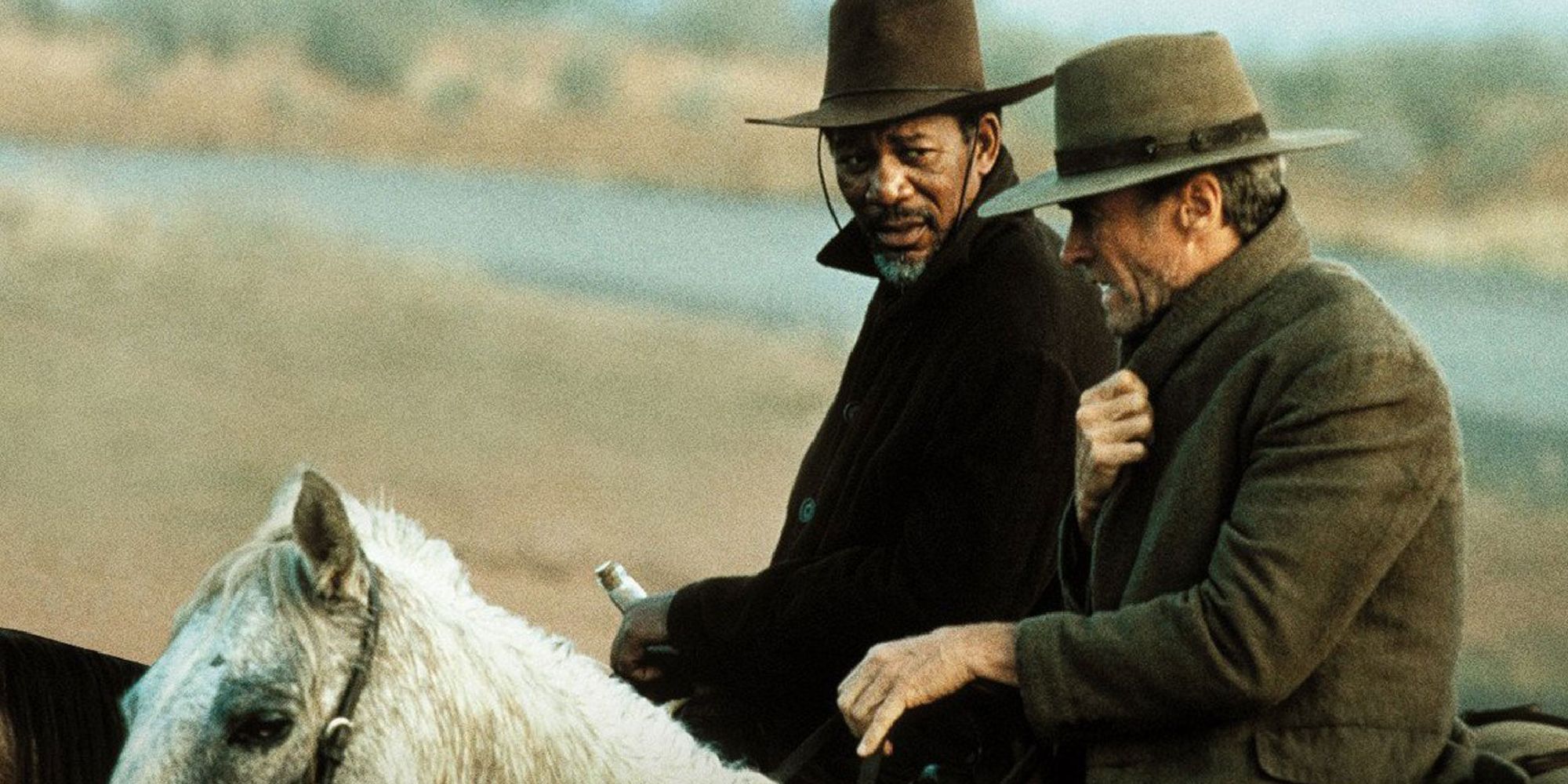 Morgan Freeman as Ned Logan and Clint Eastwood as William Munny riding horses in Unforgiven