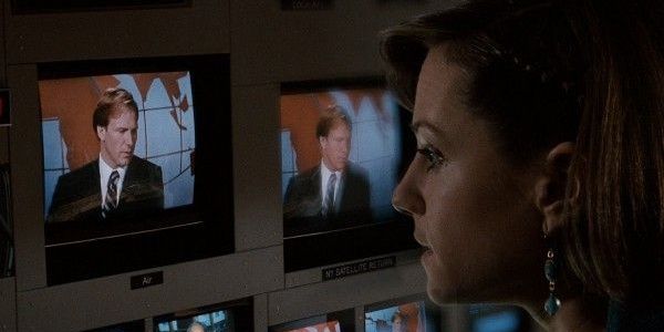 Holly Hunter watches William Hurt on the monitor on the broadcast news 