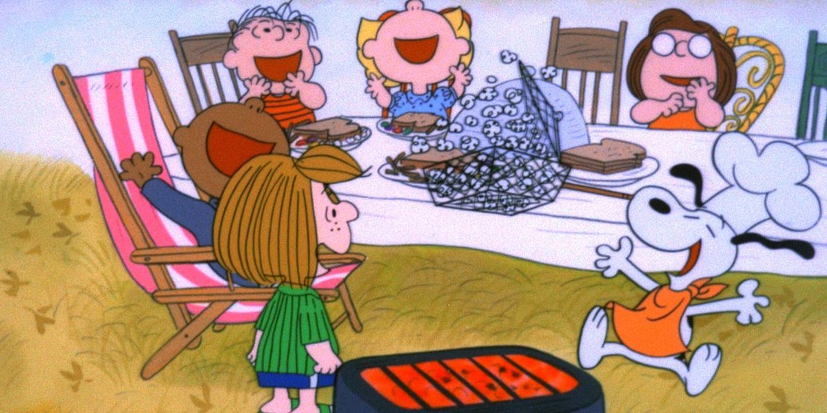 Snoopy and the Peanuts gang cheer in a scene from A Charlie Brown Thanksgiving