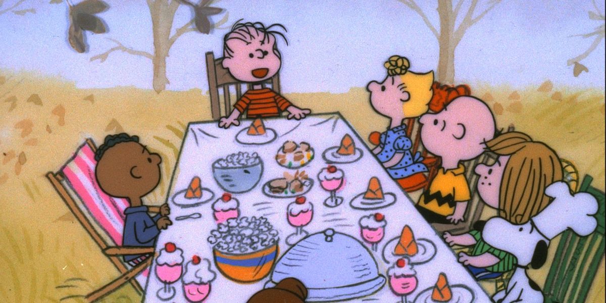 The Peanuts gang sitting down for Thanksgiving dinner