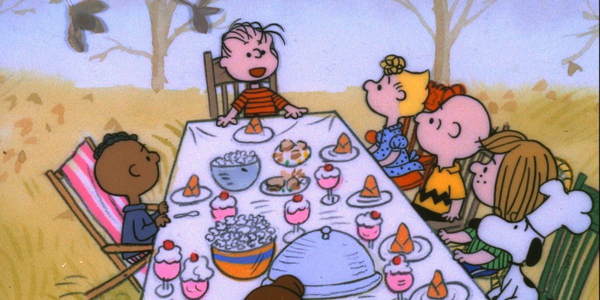 The Peanuts gang seated for Thanksgiving dinner