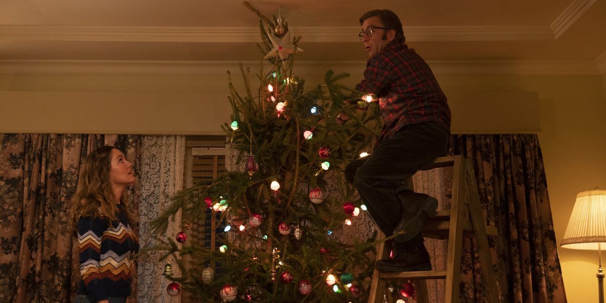 Erinn Hayes and Peter Billingsley as Sandy and Ralphie Parker setting up a Christmas tree in A Christmas Story Christmas