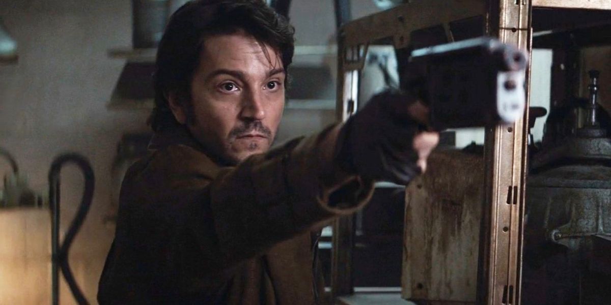 Cassian Andor pointing a gun at someone off-camera in Andor.