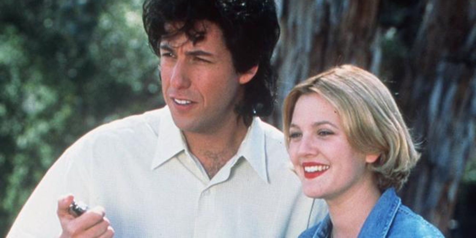 Drew Barrymore as Julia smiling next to Adam Sandler as Robbie in The Wedding Singer