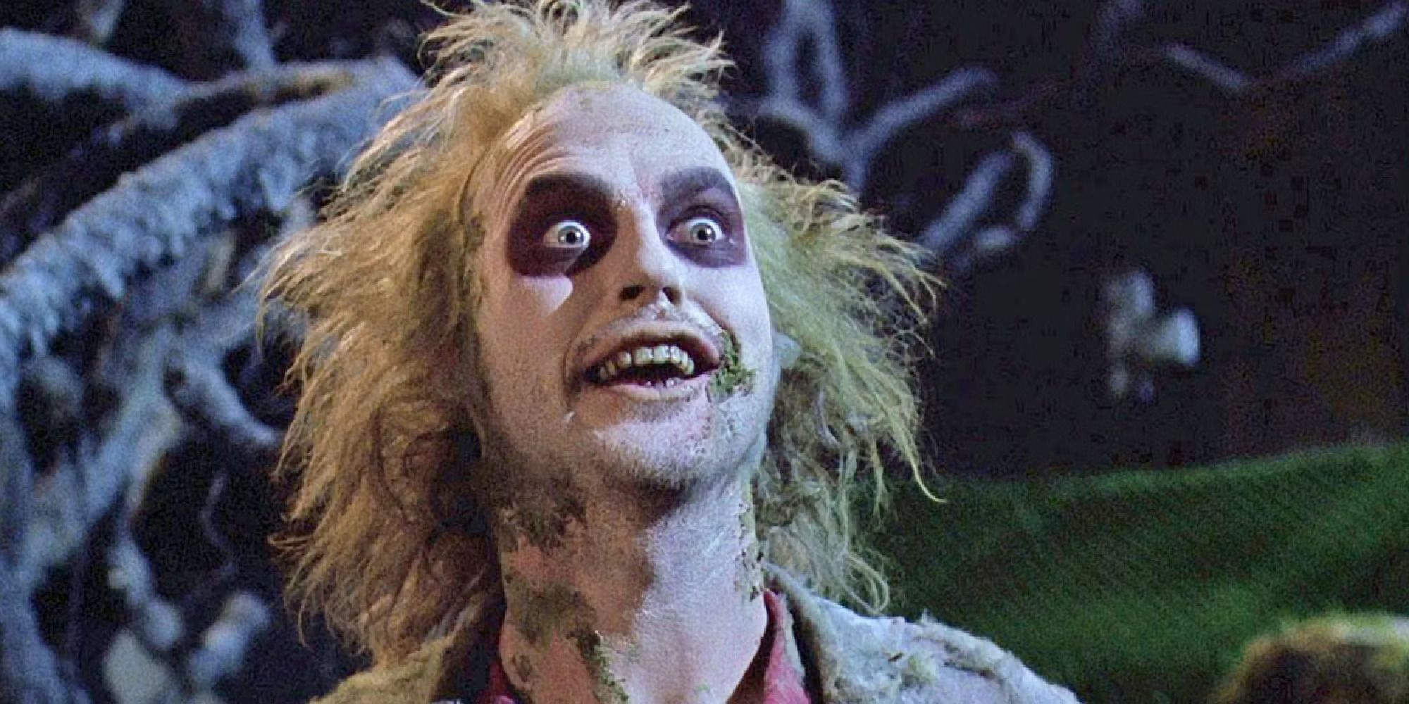 Beetlejuice smiling with his eyes wide open in Beetlejuice.