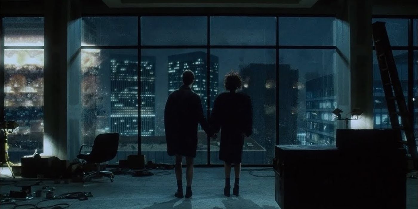 Marla Singer and the Narrator holding hands and watching buildings collapse at the end of Fight Club