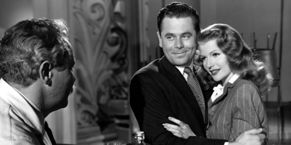 Glen Ford and Rita Hayworth hugging each other in Gilda