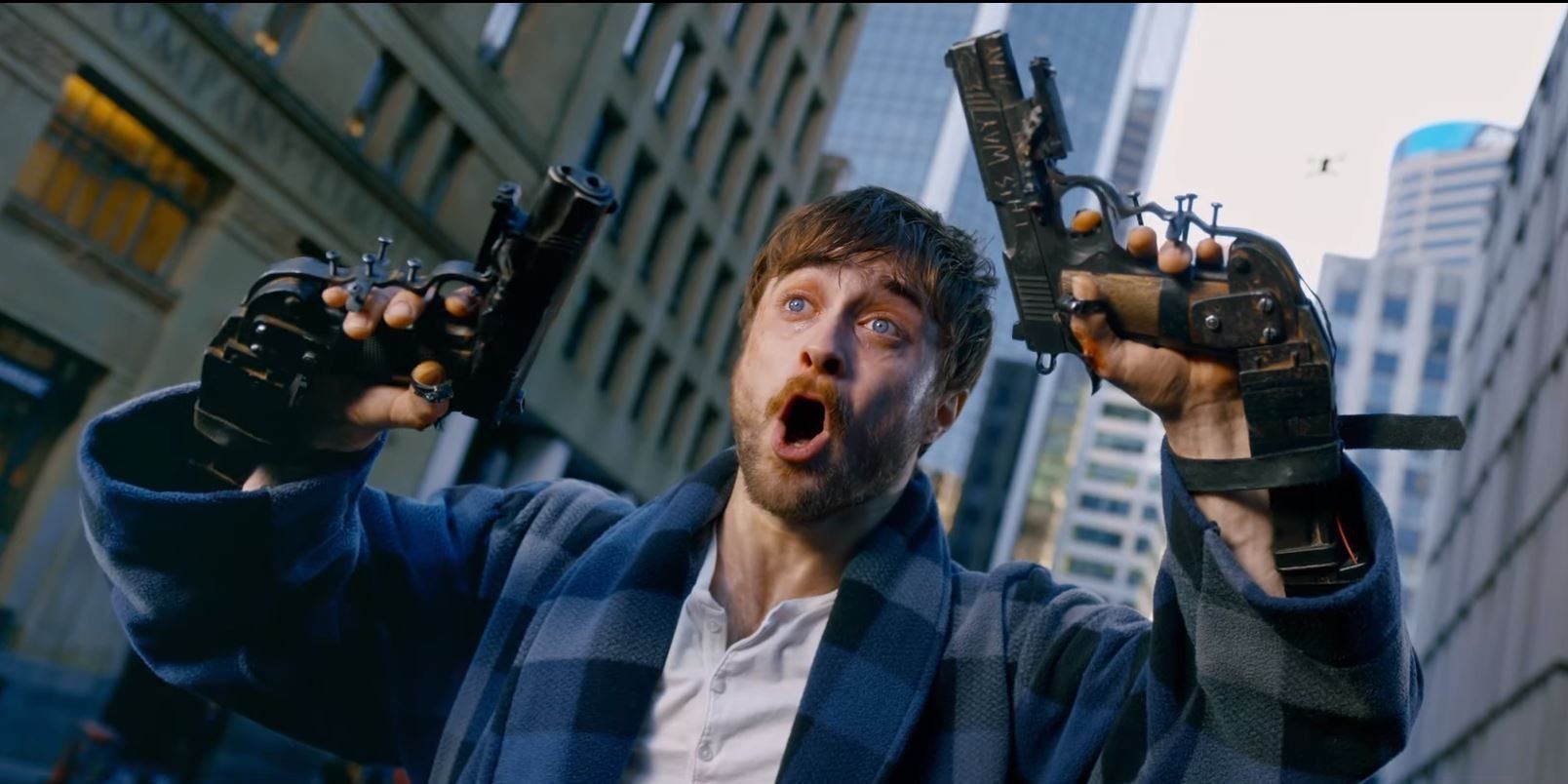 Daniel Radcliffe with guns bolted to his hands in Guns Akimbo