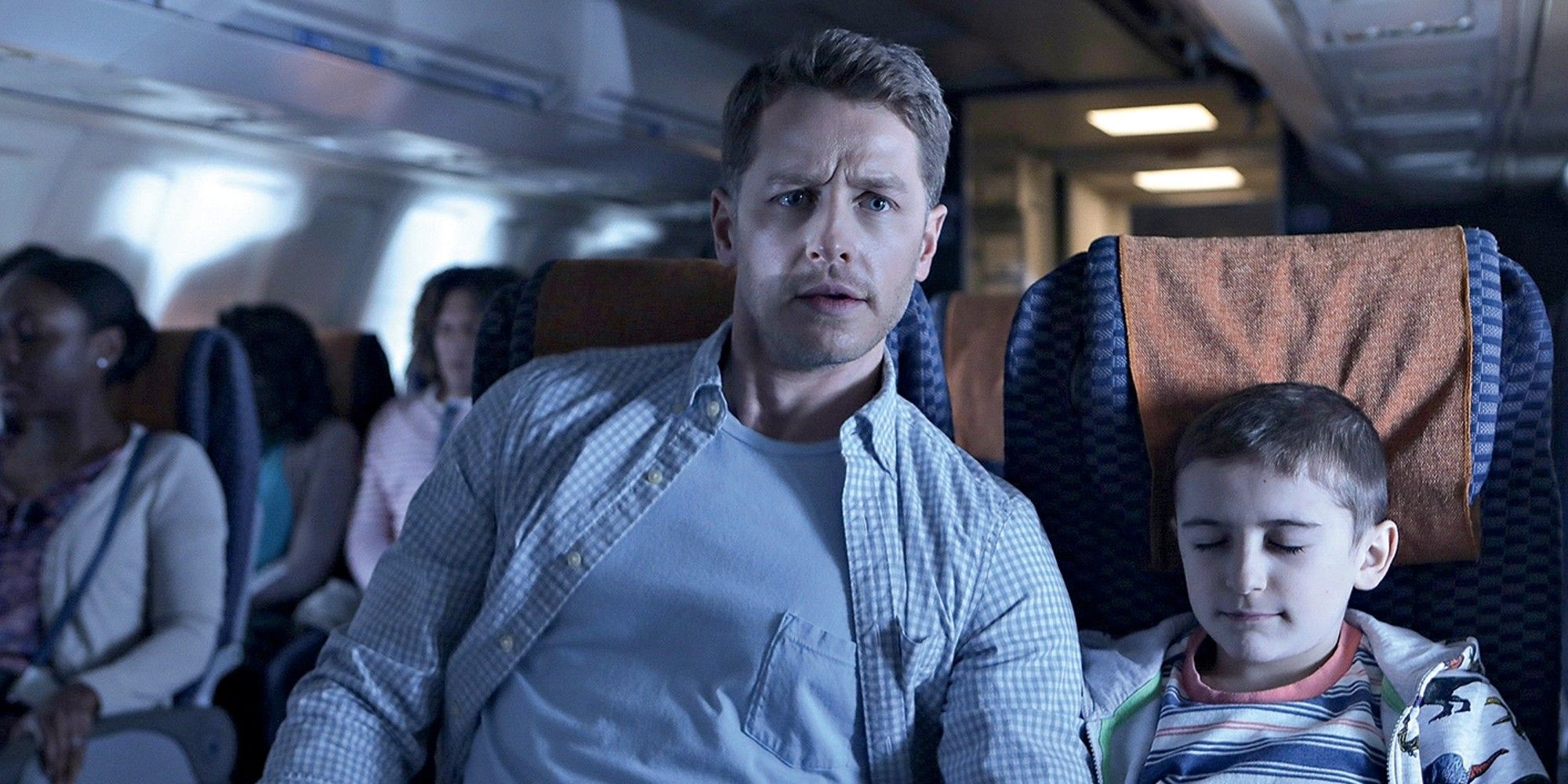 A man sitting next to a young boy on a plane in Manifest.