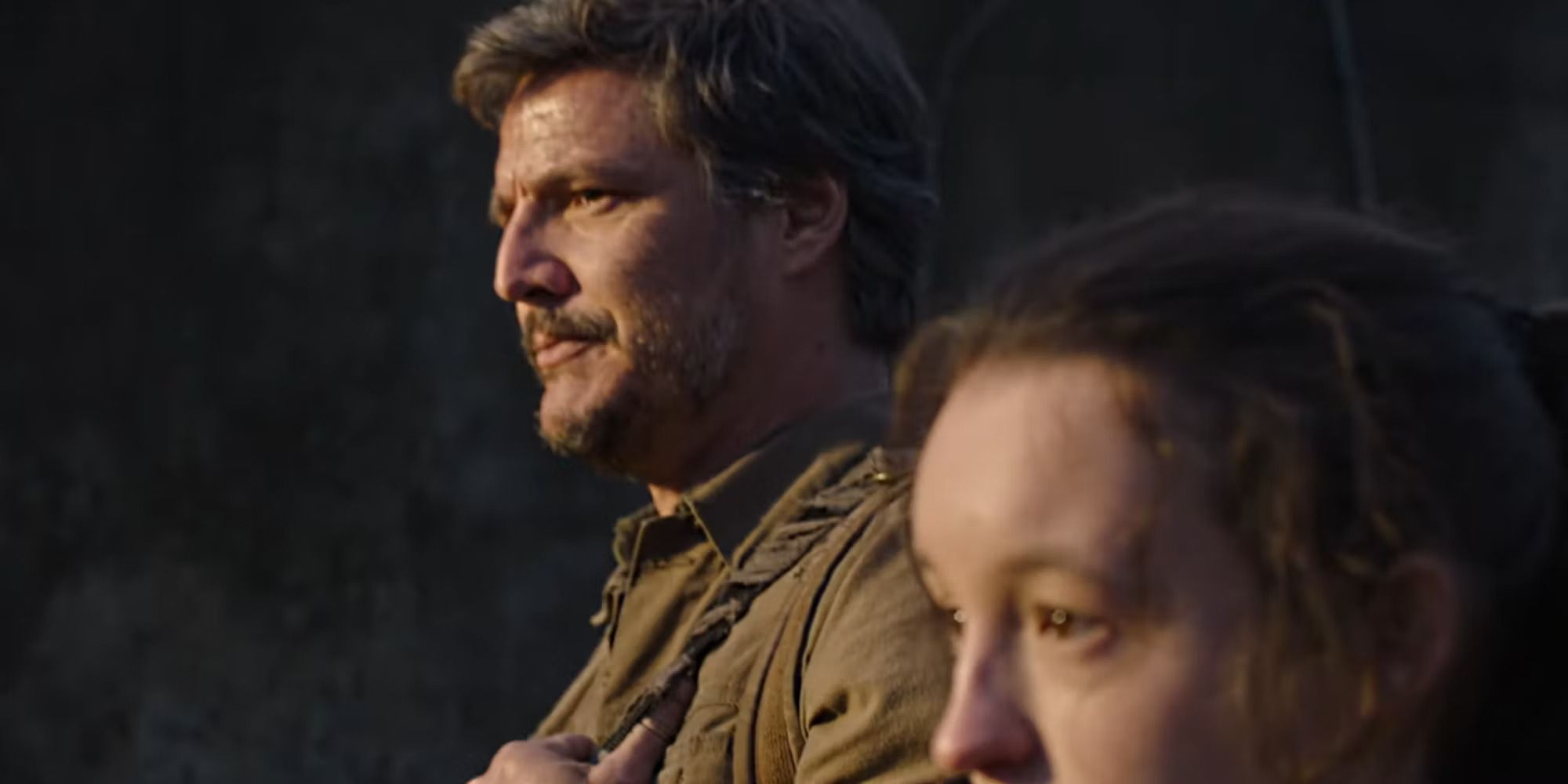 Joel (Pedro Pascal) standing beside Ellie (Bella Ramsey) in HBO's 'The Last of Us'