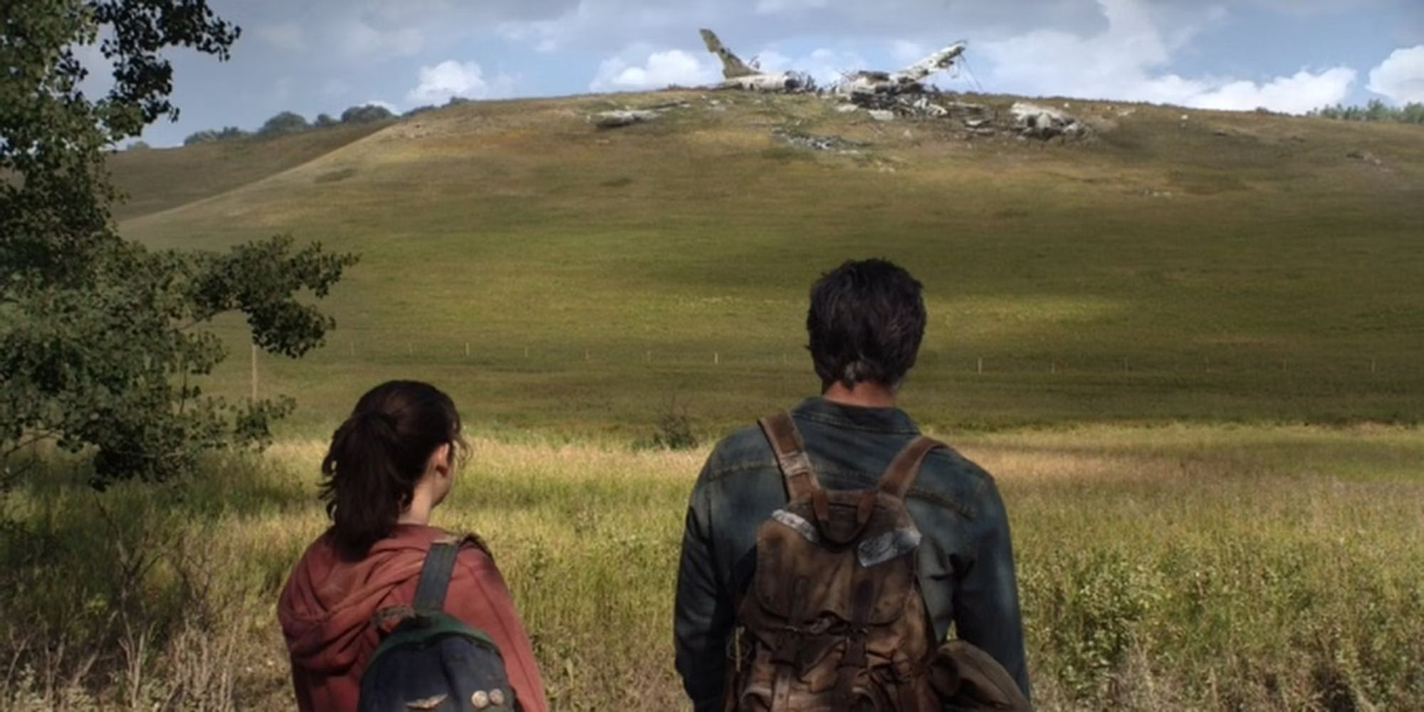 Joel and Ellie looking at a crashed plane in the HBO series 'The Last of Us'