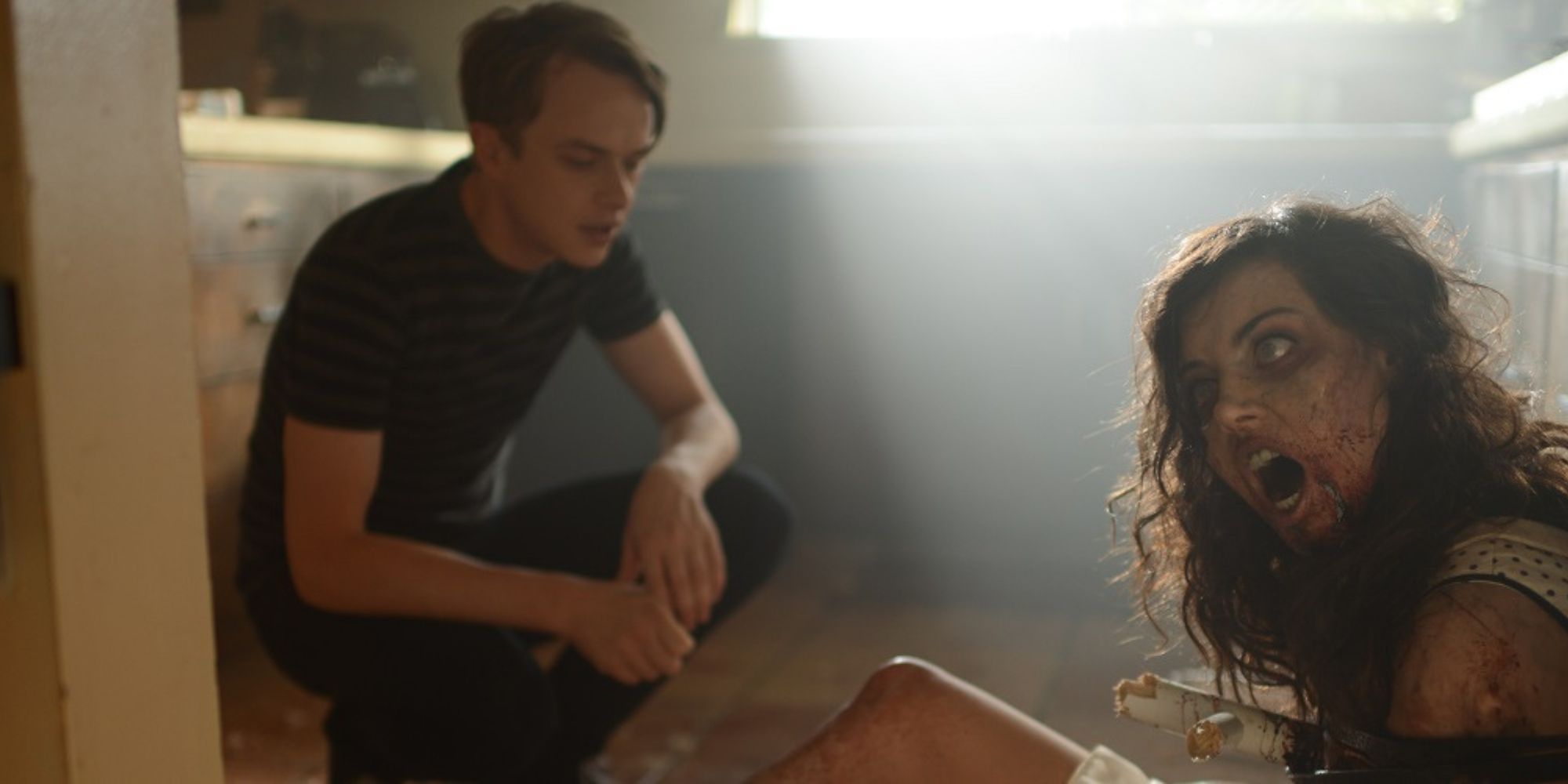A man crouching next to his girlfriend who has turned into a zombie in Life After Beth.