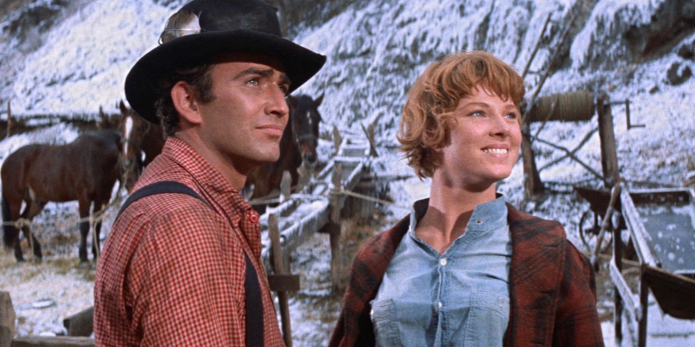A man and a woman smiling looking to the distance in Ride the High Country
