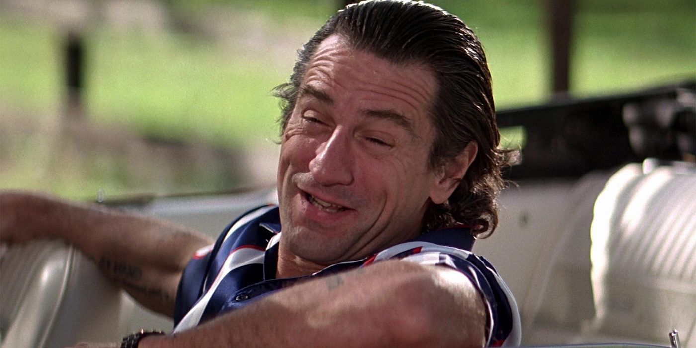 Robert De Niro as Max Caddy smiling while sitting on a convertible in the film Cape Fear