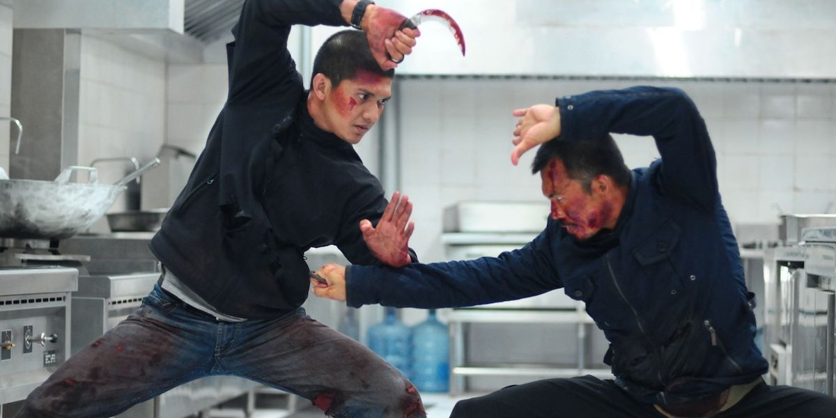 Iko Uwais as Rama fighting in The Raid 2