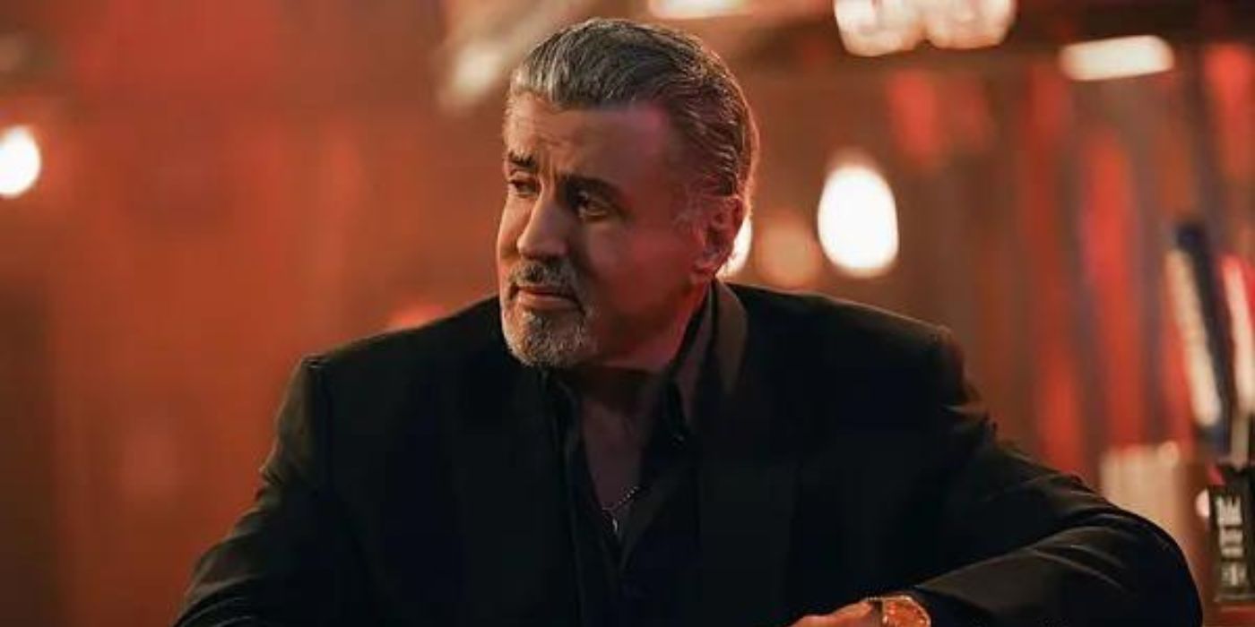 Sylvester Stallone as a general in a suit with a blurred background in Tulsa King