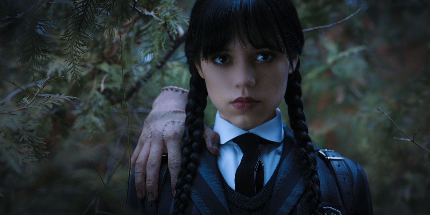 Jenna Ortega as Wednesday looking forward with Thing on her shoulder Wednesday