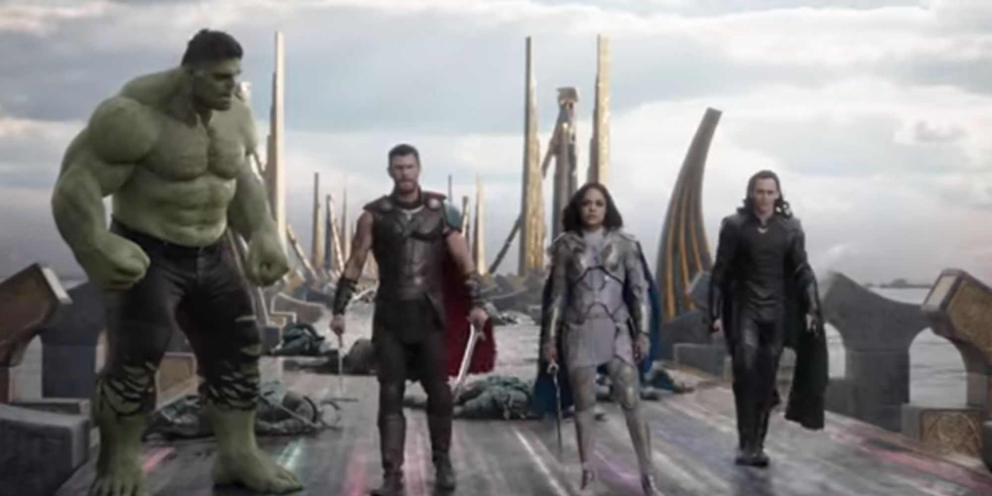 Hulk, Thor, Valkyrie, and Loki stand together on the bridge