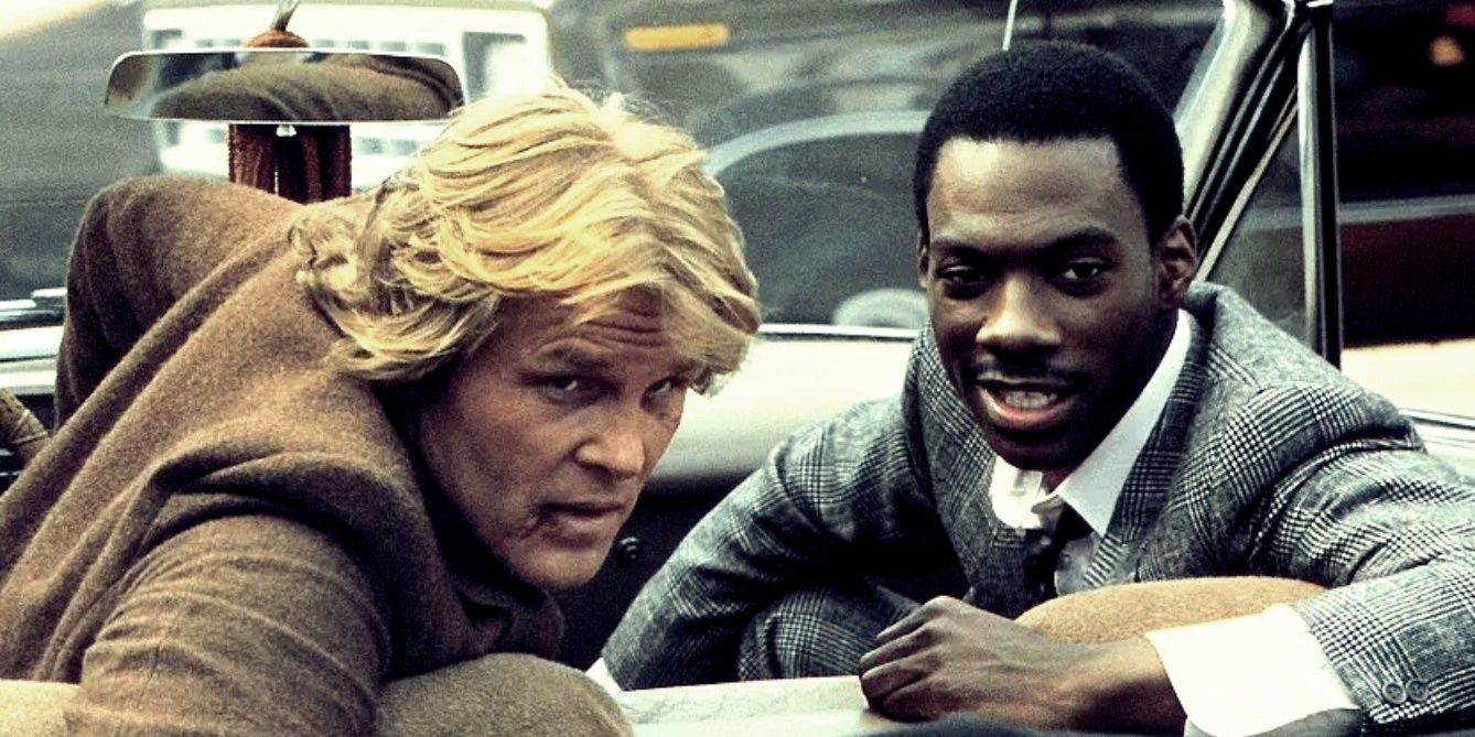 Nick Nolte and Eddie Murphy turn to look in the backseat of a car