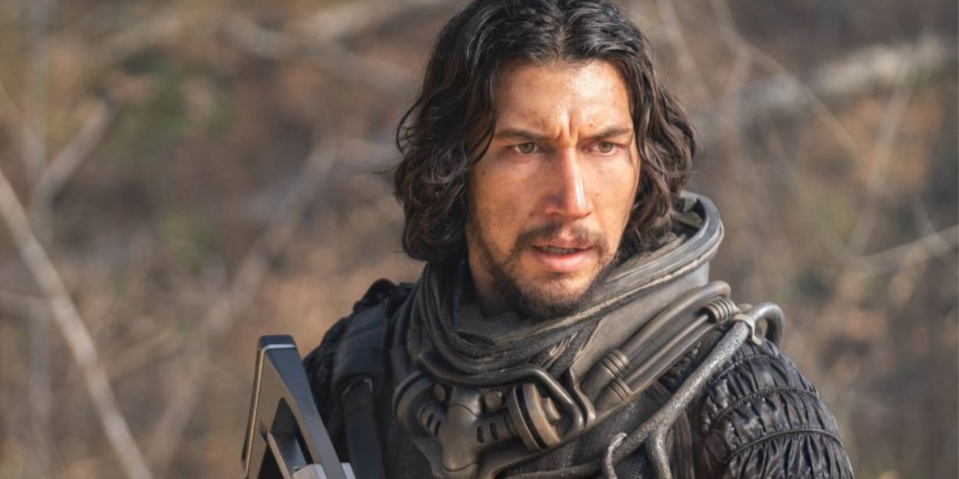 Adam Driver in a space suit holding a futuristic gun in 65