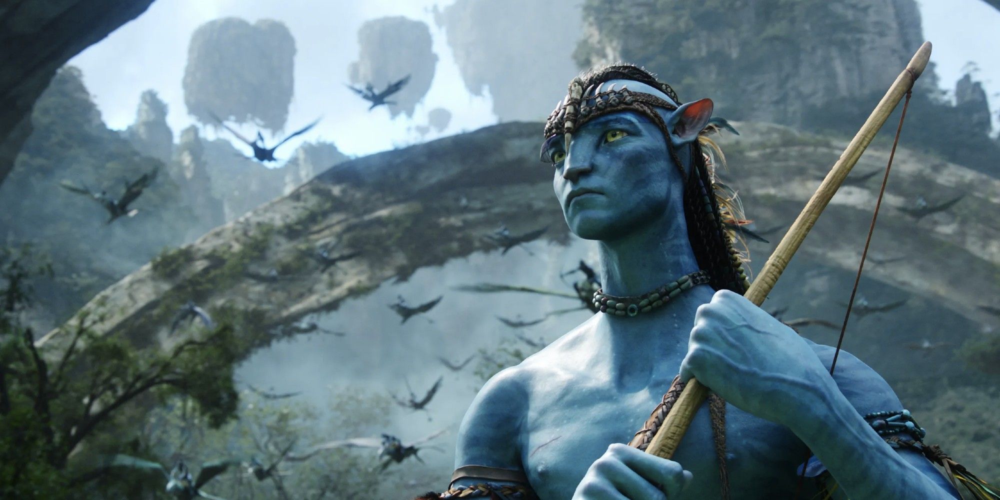 Jake Sully in his Na'vi form looking to the distance in Avatar.
