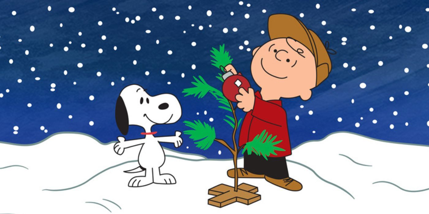 Charlie Brown and Snoopy hanging the red ornament on the wimpy tree