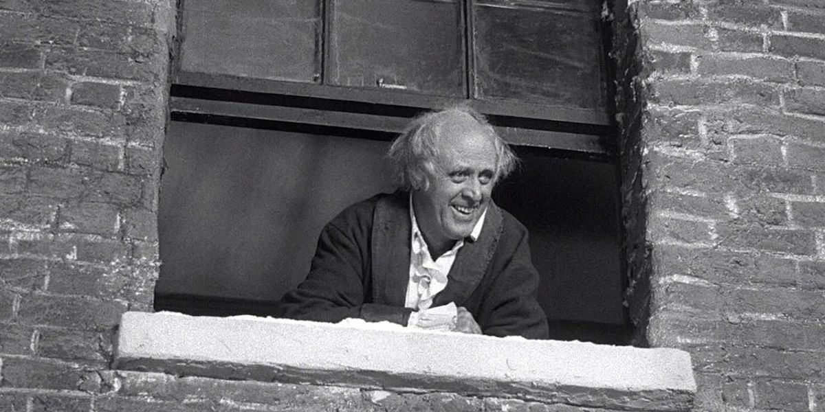 Alastair Sim as Ebenezer Scrooge looking out his window in A Christmas Carol (1951)
