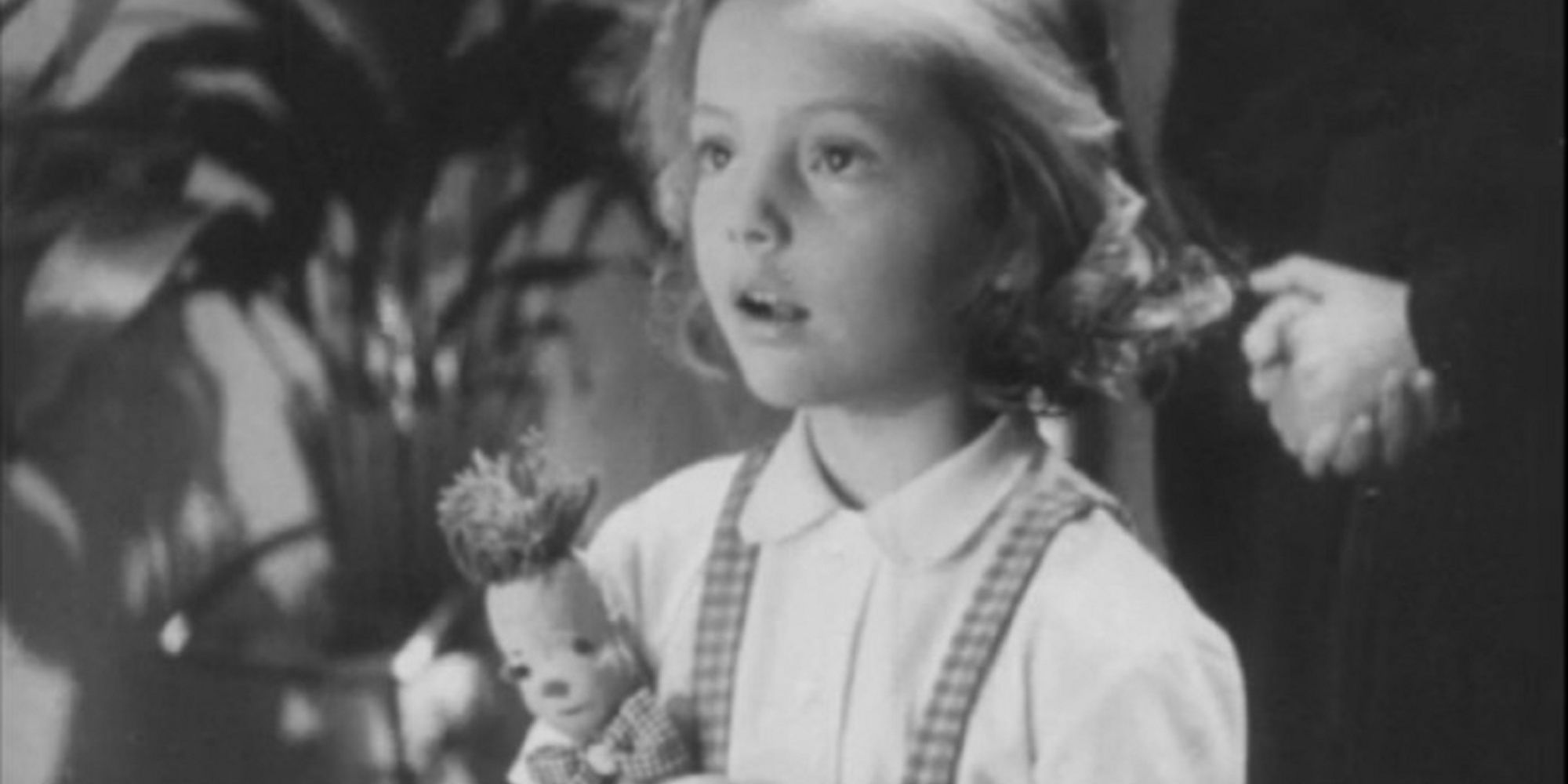 The little girl with her rag doll in 'A Christmas Dream.'