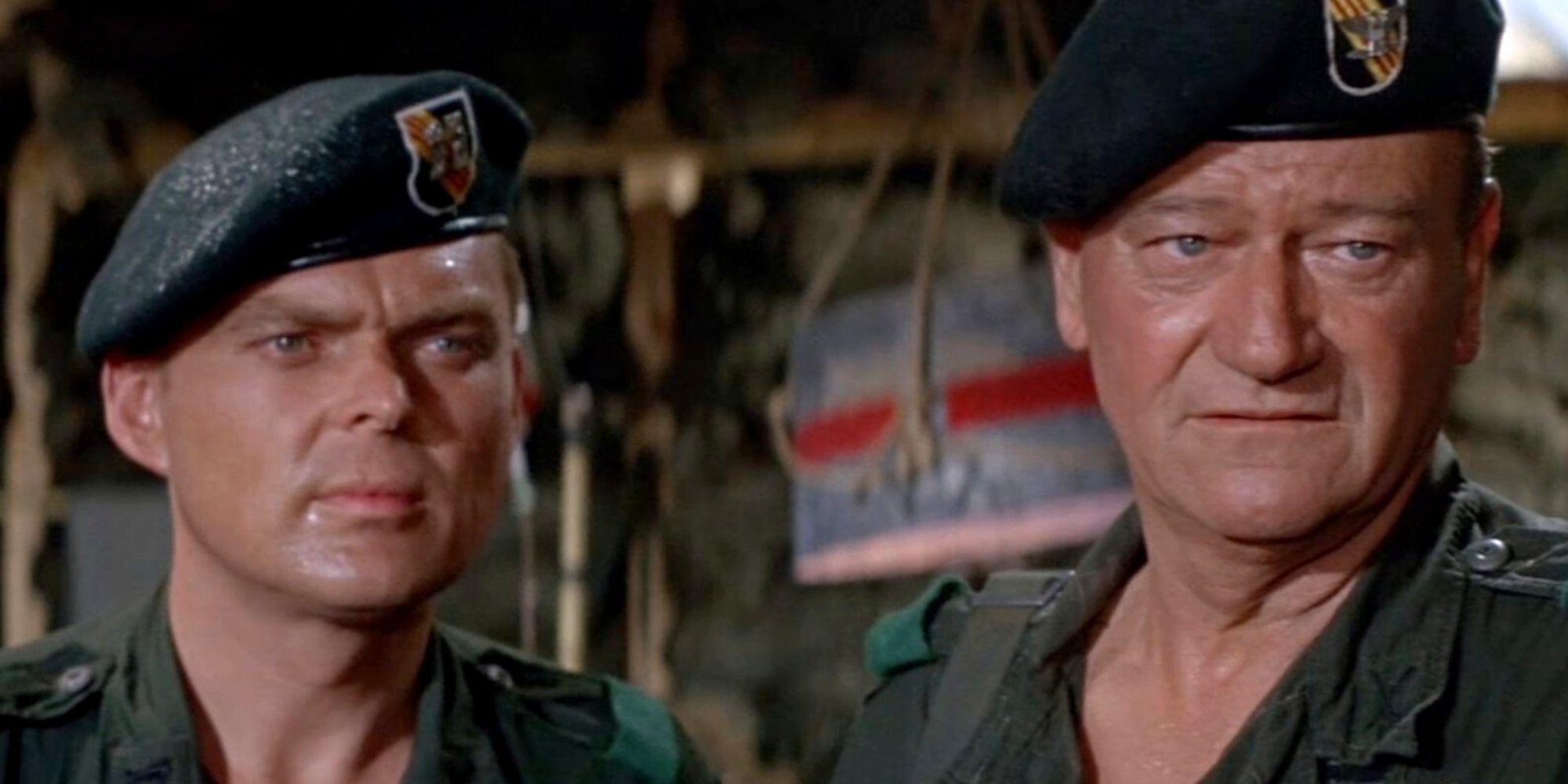 Aldo Ray and John Wayne standing next to each other looking forward in The Green Berets