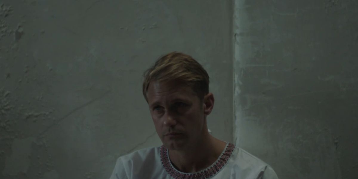 Alexander Skarsgard against a concrete wall